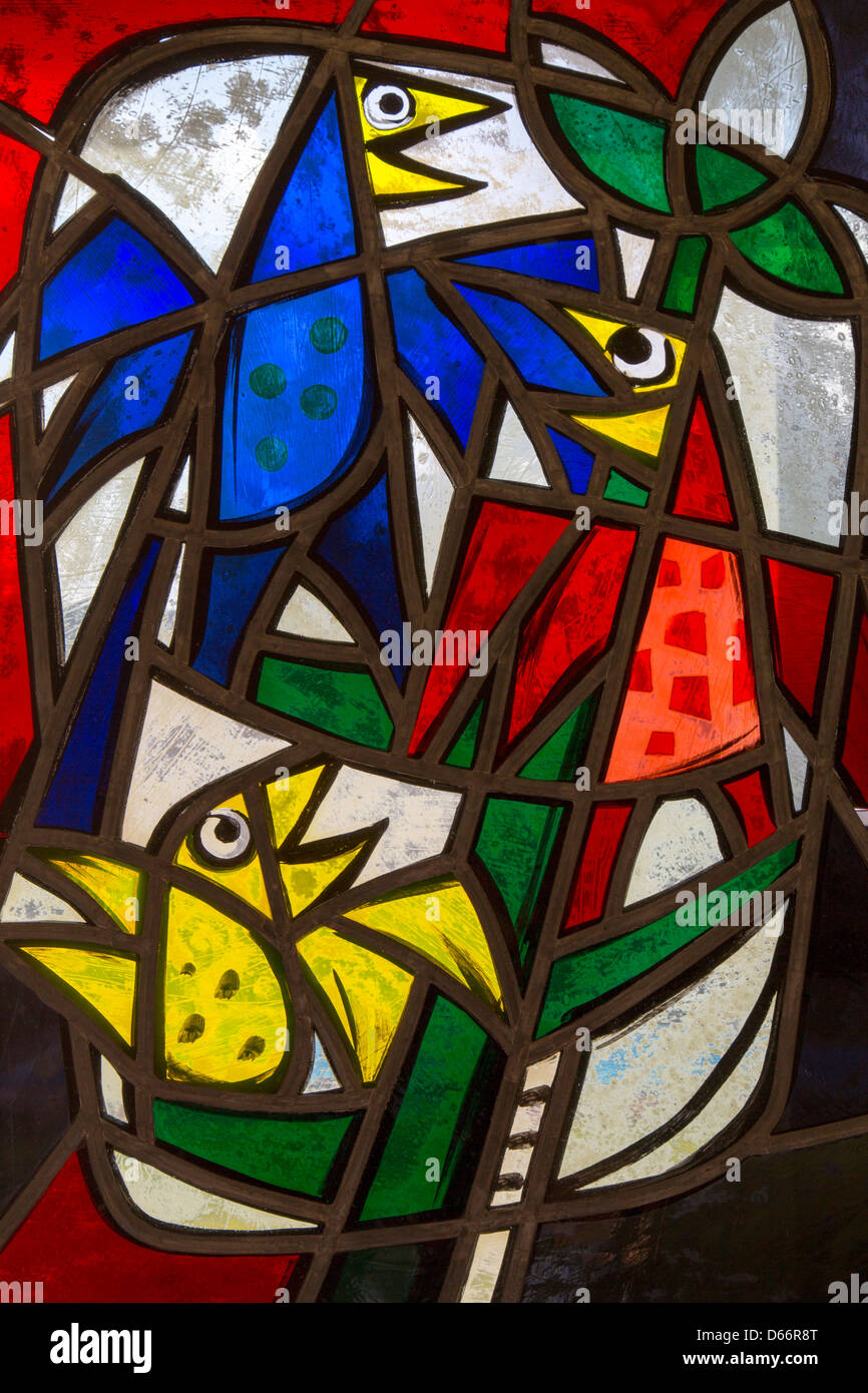 A shot of a lead light window depicting colorful birds frolicking Stock Photo