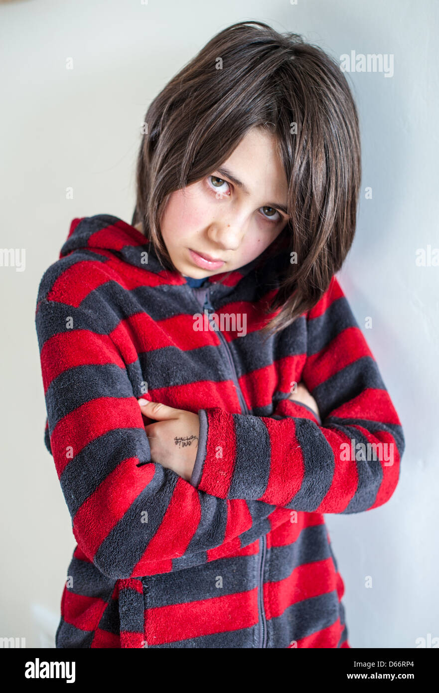 Sulky And Angry Little White Girl With Dark Hair Looking Straight