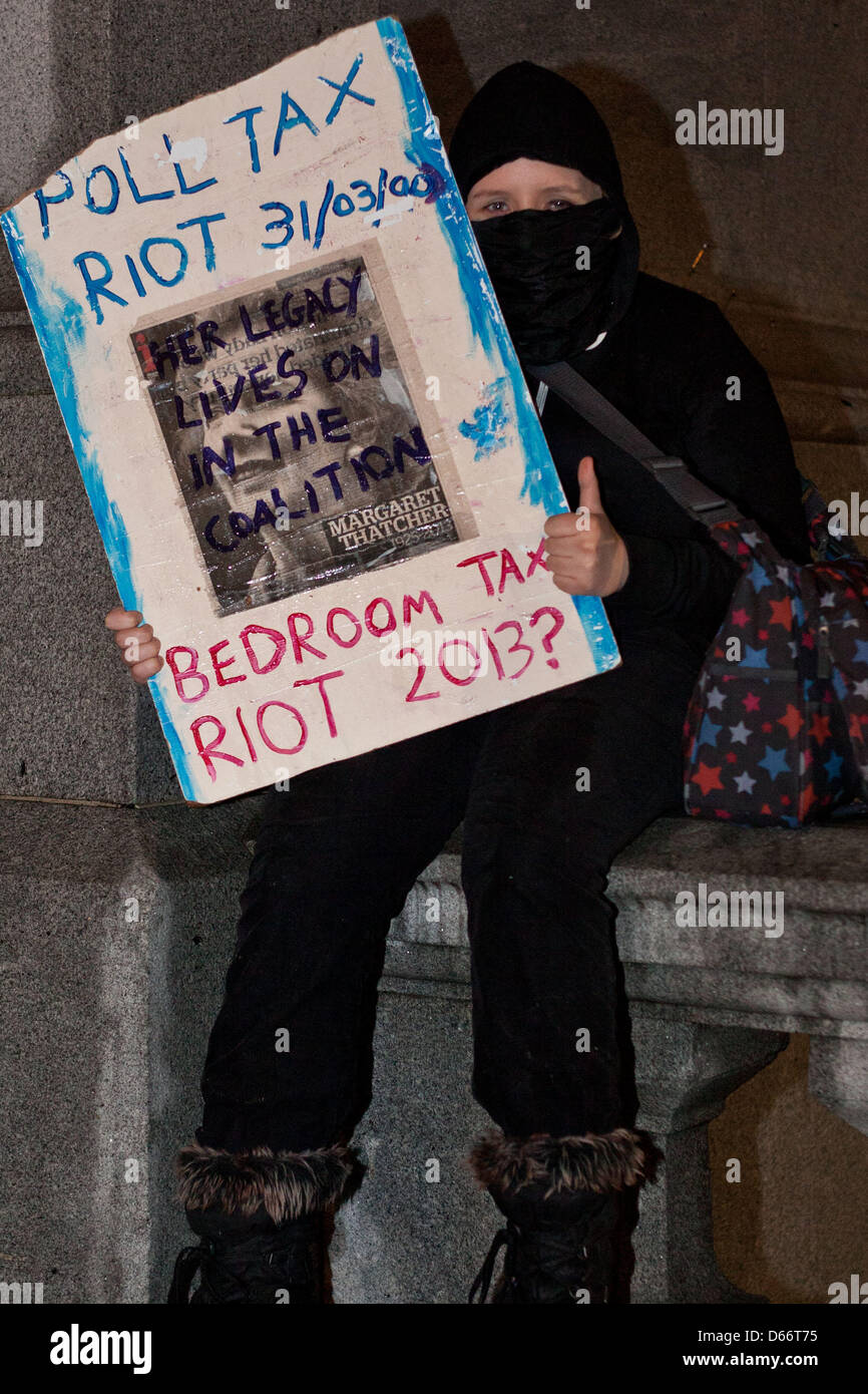 London, UK. Saturday 13th April 2013 A young party protestor holds a placcard with reference to the Poll tax riot.The party had been planned for the first Saturday after the former prime minister death. Nelson Pereira/Alamy Live News Stock Photo