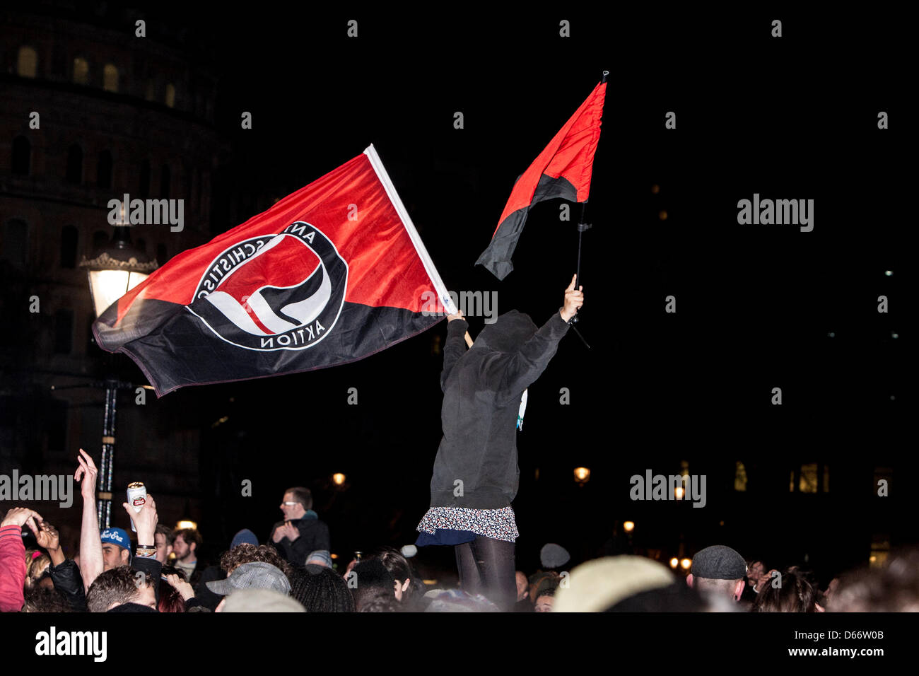 London, UK, 13 April 2013. Anarchists waving the anarchist red and