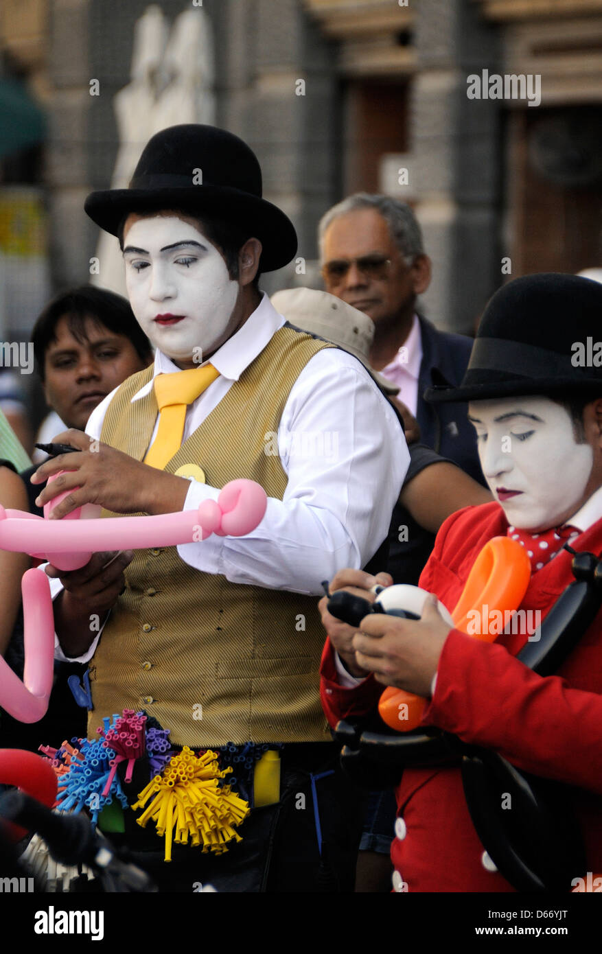 White-faced street performers entertain crowds outside Catedral Metroploitana in Plaza de Armas. Santiago, Chile Stock Photo