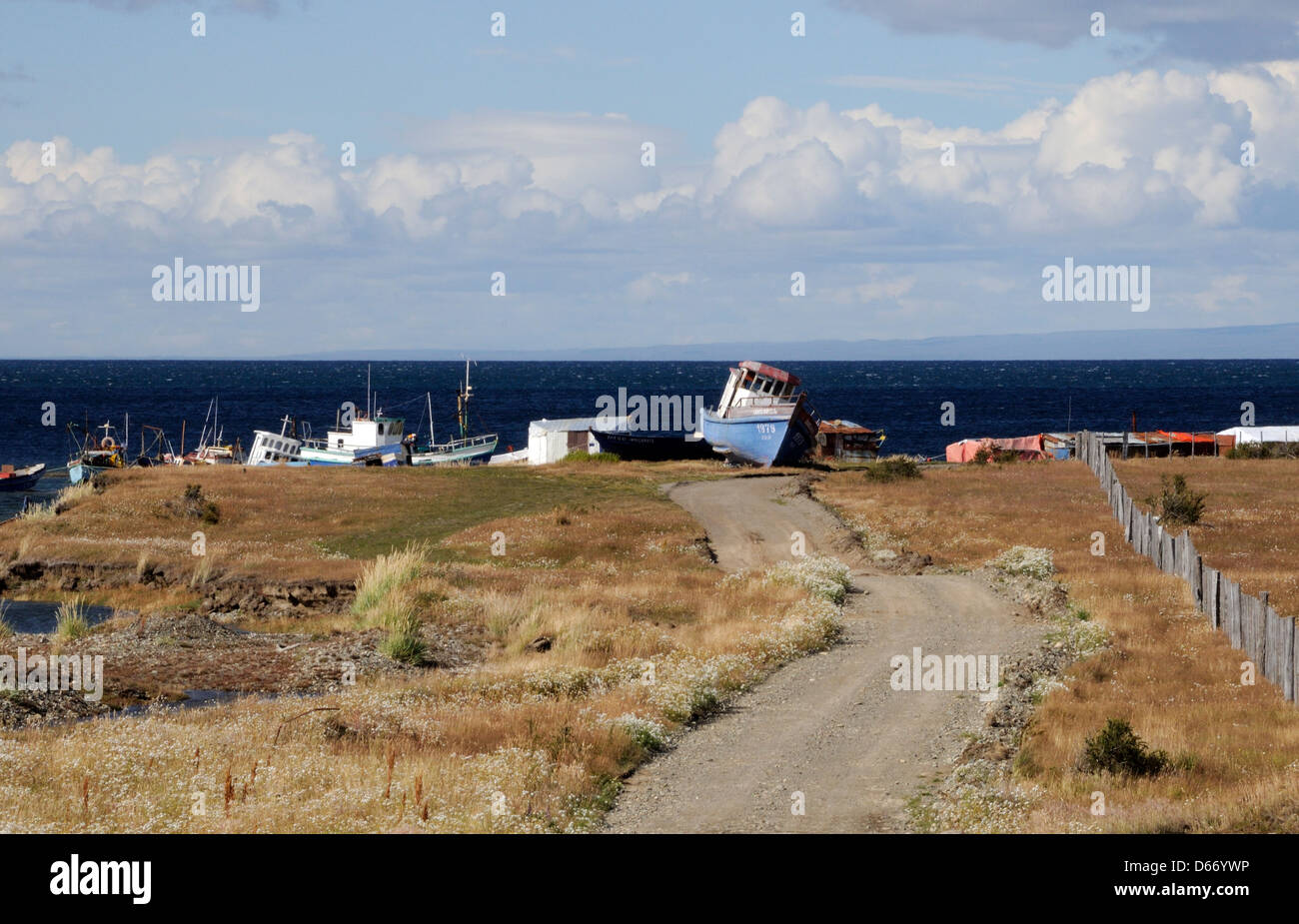 Old wooden fishing boats pulled up above the beach on the Strait of Magellan .  Punta Arenas, Chile. Stock Photo