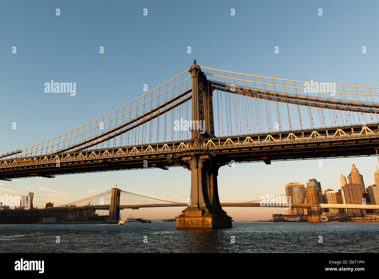 Manhattan and Brooklyn Bridges at sunrise with Lower Manhattan in the
