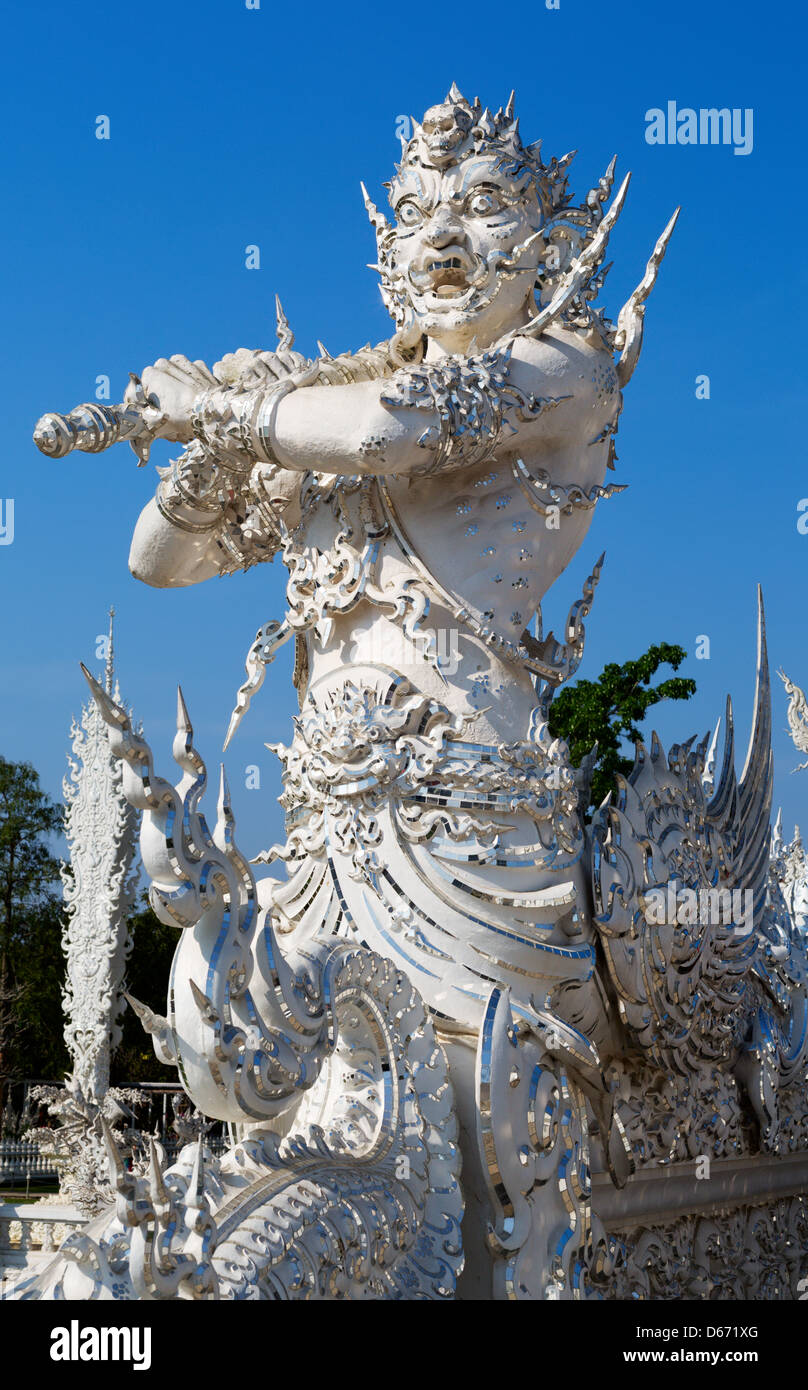 sculpture soldier guards the entrance to the white temple in Chiang Mai