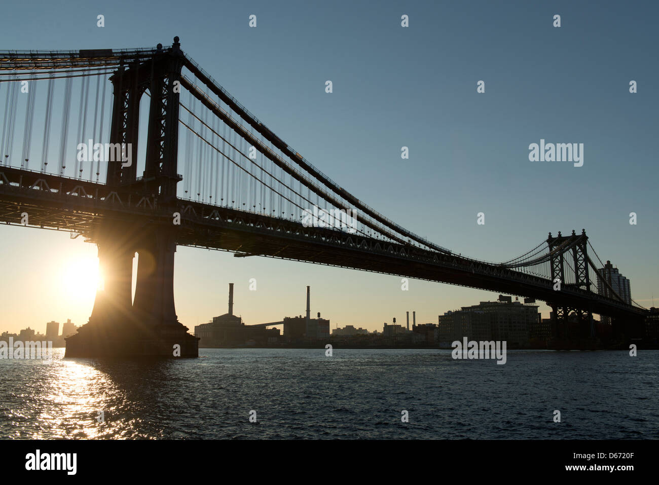 Silhouette of Manhattan Bridge at sunrise on a clear sunny morning. Stock Photo