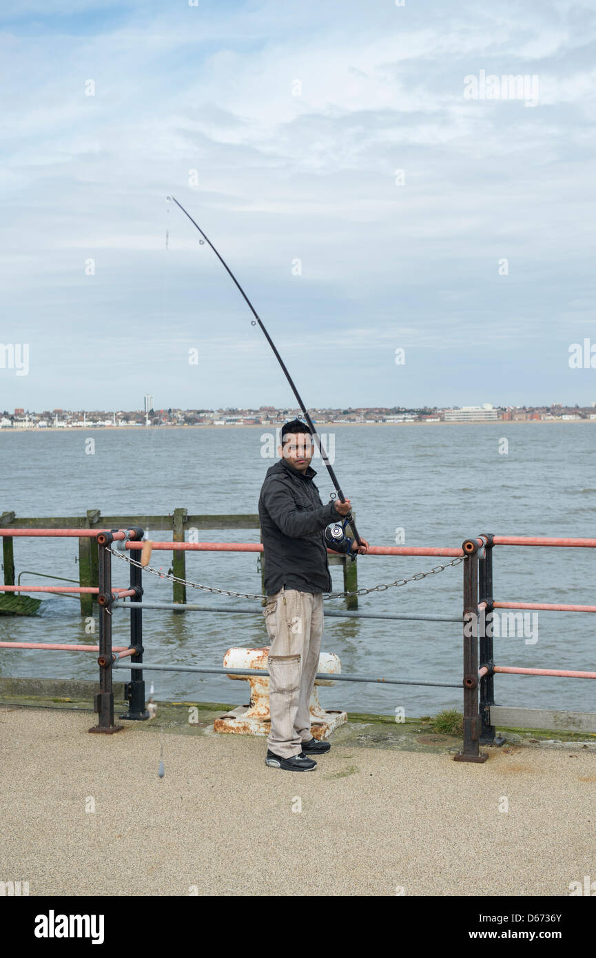 Anglers fishing at the end of Southend Pier, Essex, UK. It is the world's longest pleasure pier at 1.3 miles in length. Stock Photo