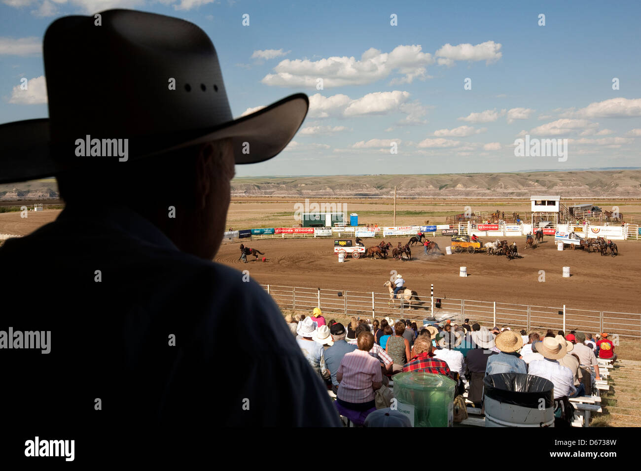 A cowboy in silhouette watches the rodeo Stock Photo
