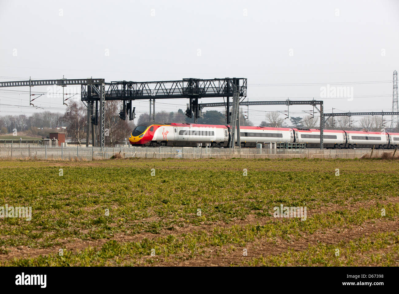 A Virgin train passing under a signals gantry on the West Coast ...