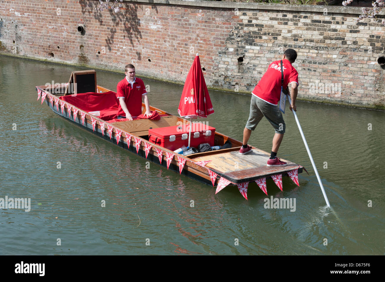 Cambridge, UK. 14 April 2013. A colourfully decorated punt sells drinks and snacks on the River Cam. The river was busy with tourists enjoying the warmest day of the year so far with temperatures hitting 20 degrees centigrade. Spring weather finally arrived after weeks of cold wet weather. Julian Eales/Alamy Live News Stock Photo