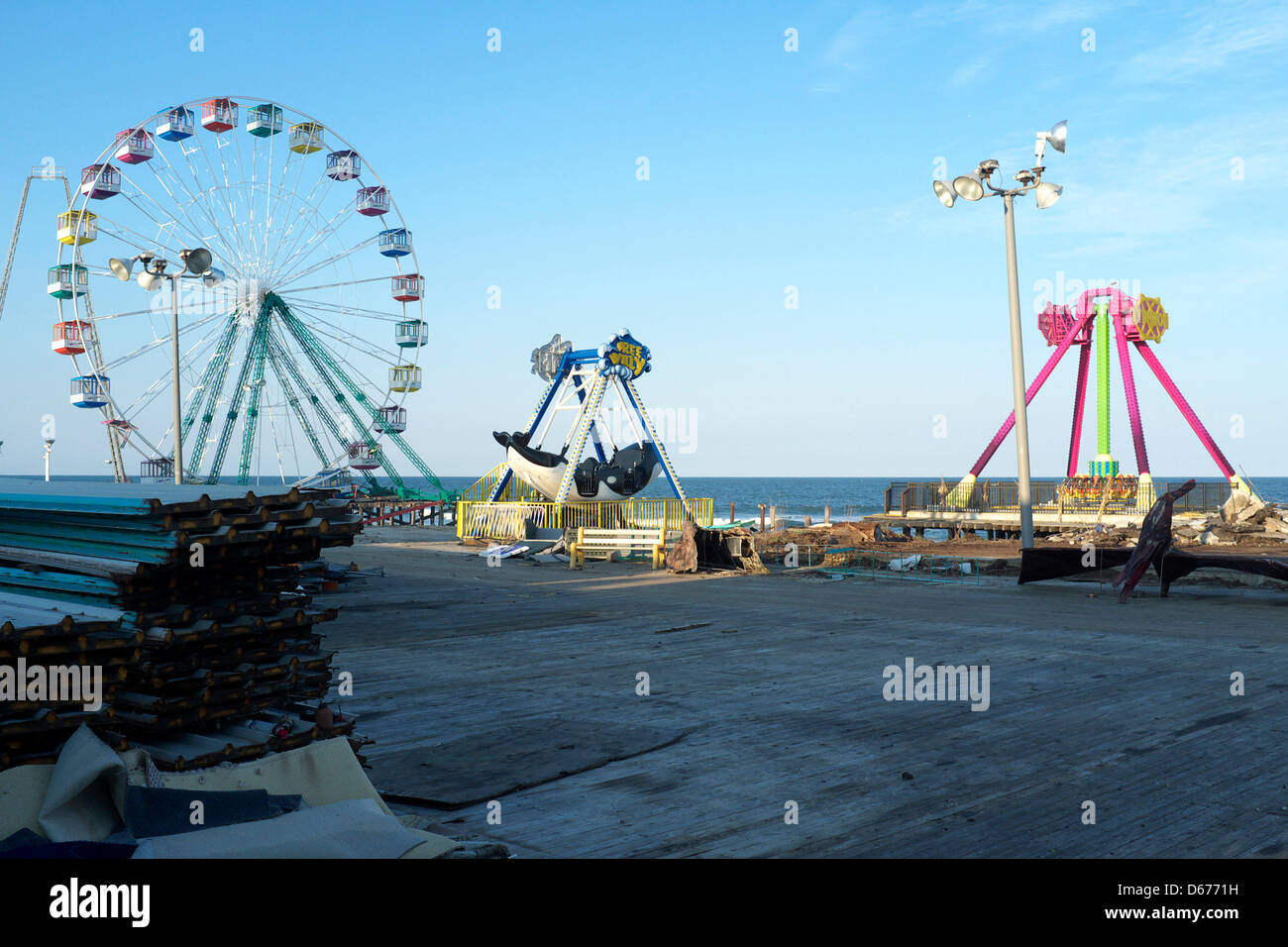Completed section of boardwalk in Seaside Heights, New Jersey, USA with Ferris Wheel in the background.  This section of the boardwalk is not yet open to the public. The boardwalk was destroyed by Hurricane Sandy in October of 2012.  Seaside Heights is racing to complete the boardwalk before Memorial Day and the start of the summer season Stock Photo