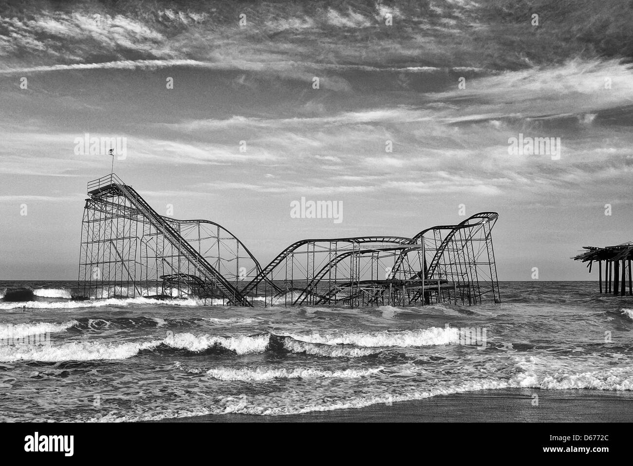 The Jet Star roller coaster still sets in the Atlantic Ocean in Seaside Heights, NJ USA in black and white.  The roller coaster was deposited there by Hurricane Sandy in October 2012 and was removed in May of 2013 Stock Photo