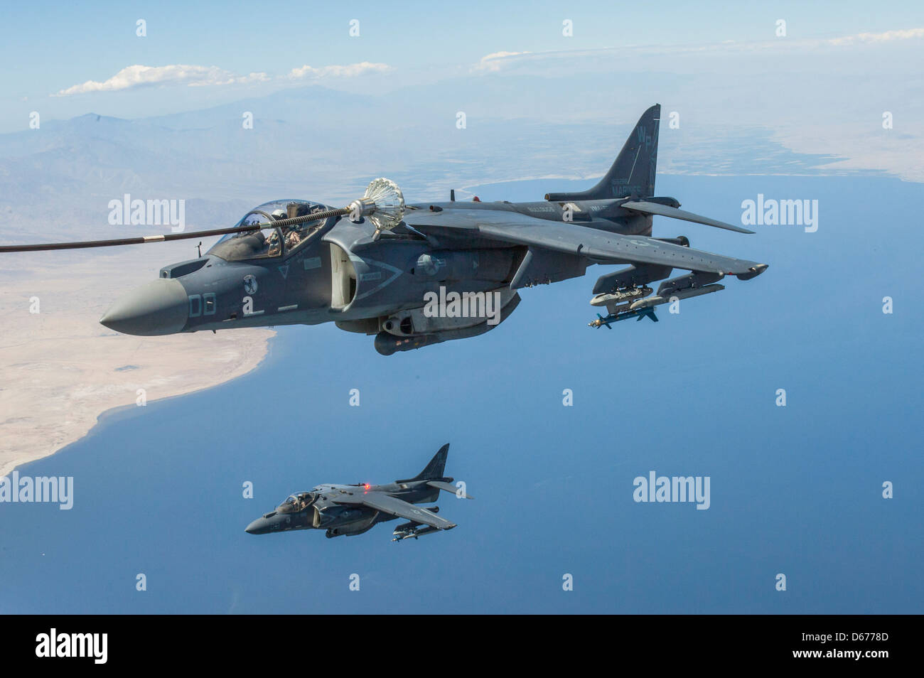 Maj. James Vallario, an AV-8B Harrier pilot with Marine Aircraft Group 13, bottom, and Maj. John Grunke, an AV-8B Harrier pilot with Marine Aviation Weapons and Tactics Squadron 1, top, train in their aircraft during the spring Weapons and Tactics Instructors' Course hosted by MAWTS-1 at Marine Corps Air Station Yuma, Ariz., March 30. WTI is hosted twice a year, once in the spring and once in the fall. Stock Photo