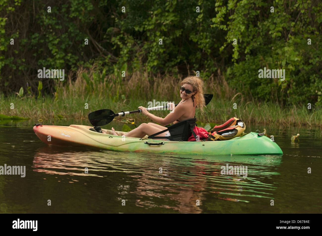 Girl kayaking down the Haines Creek River in Lake County Leesburg, Florida. Stock Photo