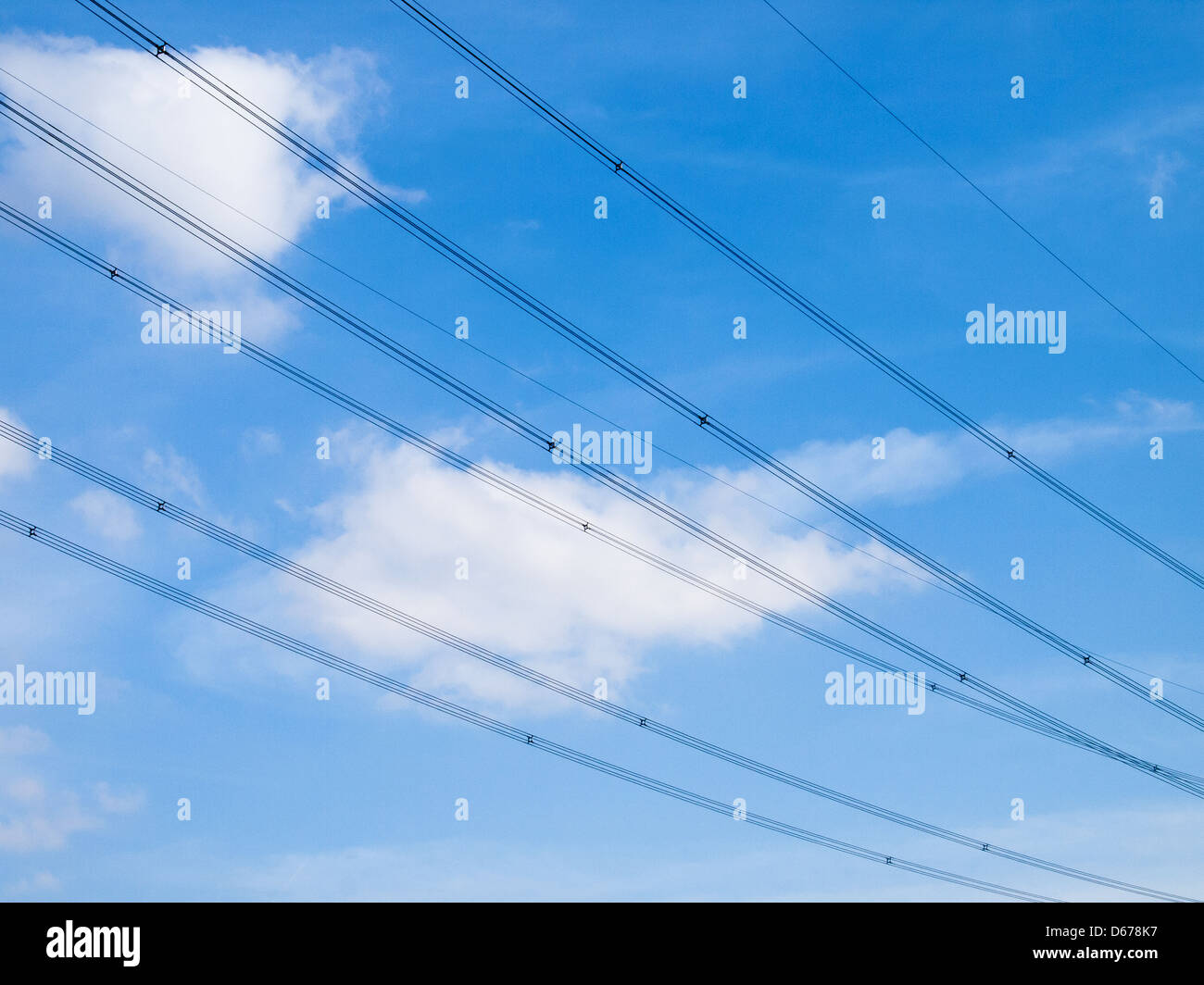 high voltage wires with a blue sky Stock Photo - Alamy