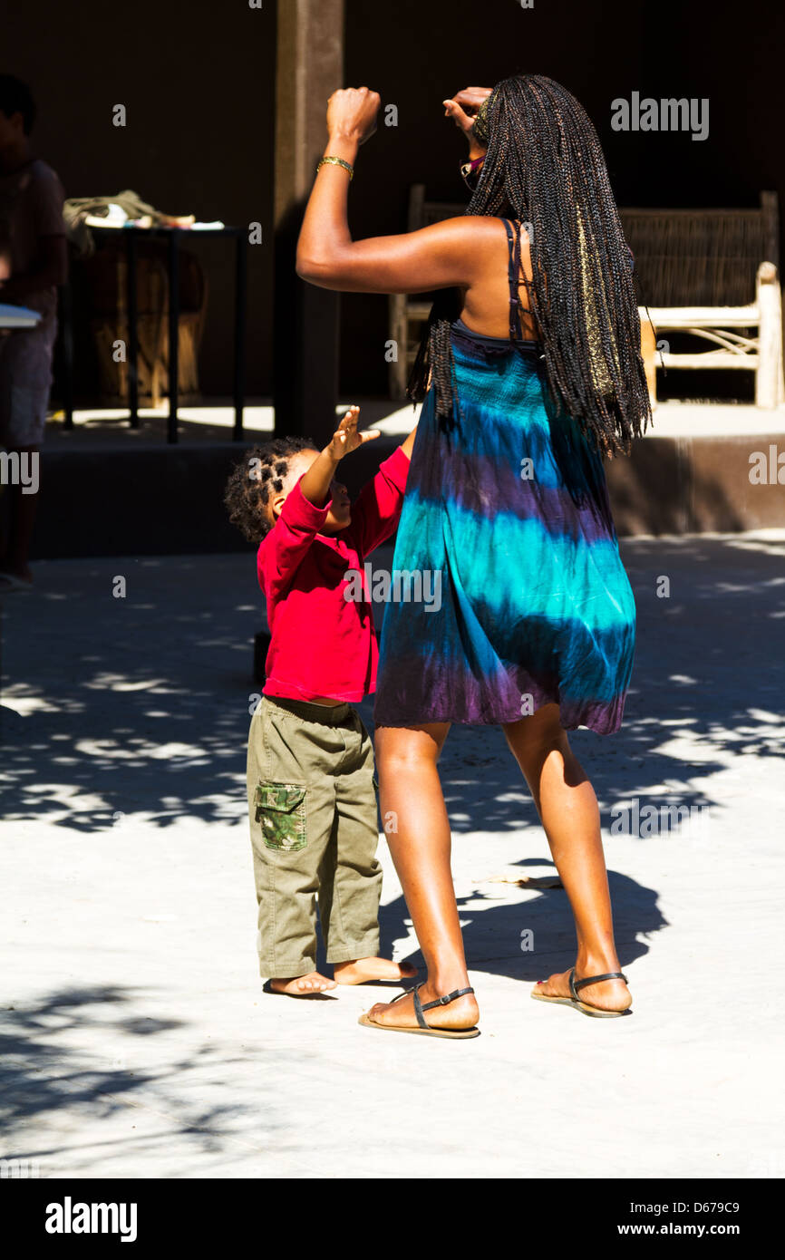 A little boy dancing with his mother near Todos Santos, Mexico Stock