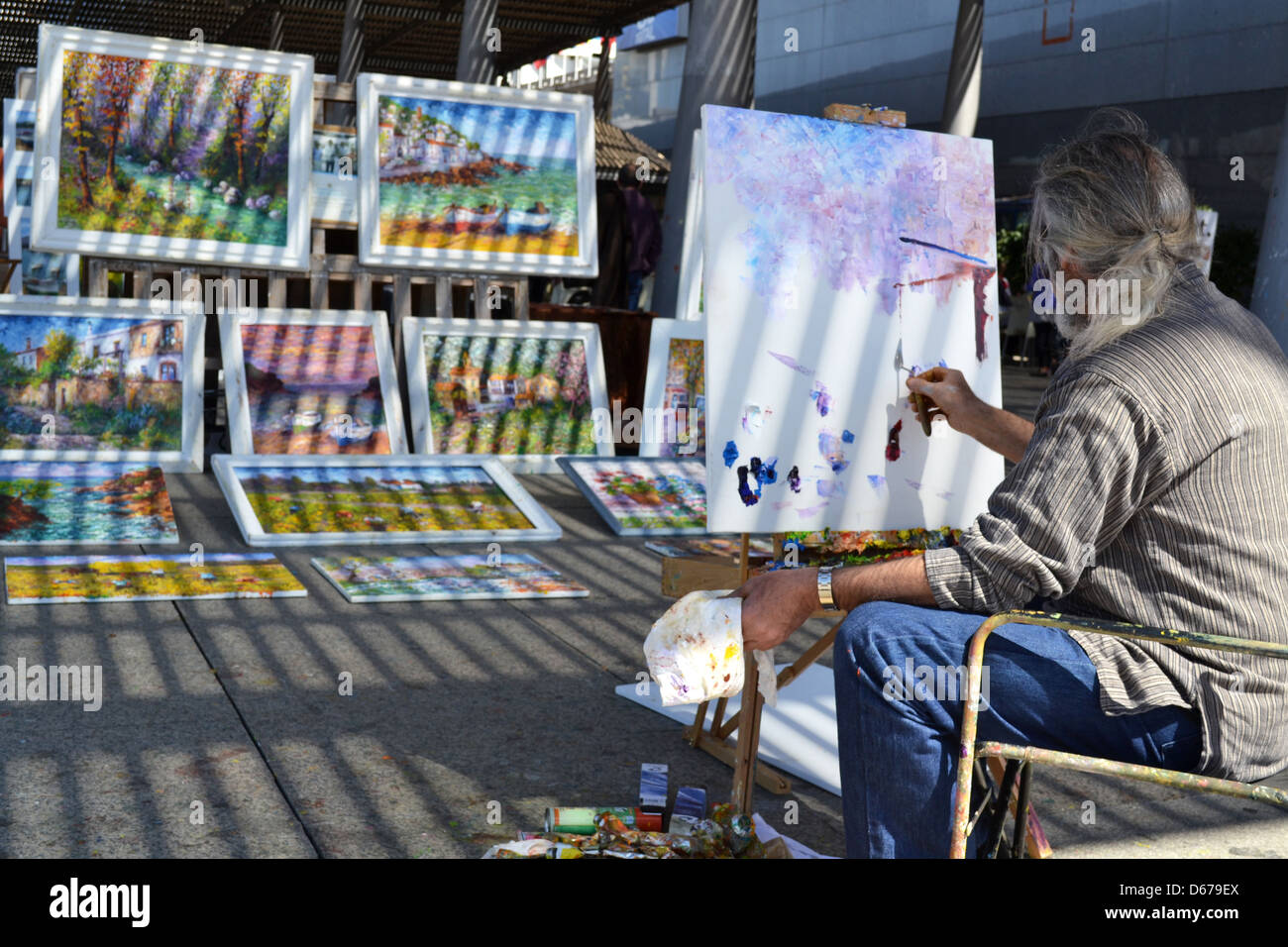 Painter on barcelona marina, Barcelona, Catalonia, Spain. Stock Photo