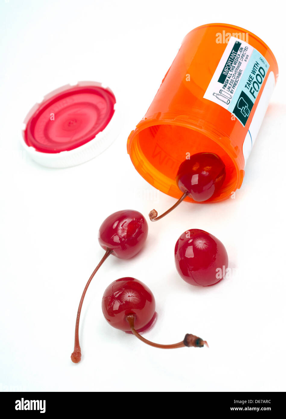 4 Red Cherries Roll out of Pharmacy Medicine Container Stock Photo