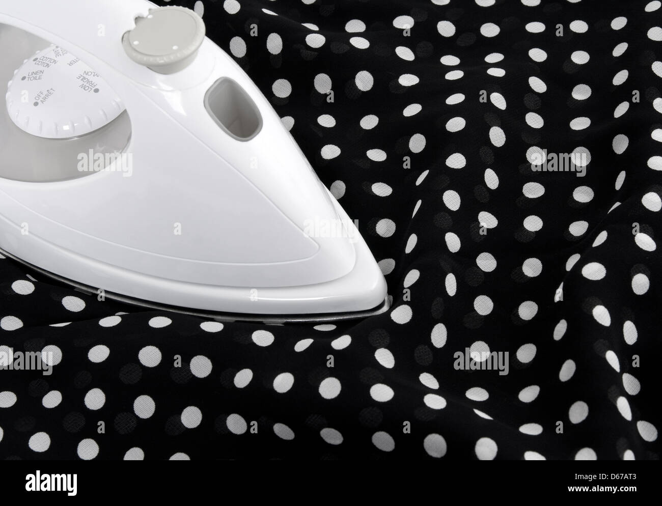 Ironing delicate black and white polka fabric Stock Photo Alamy