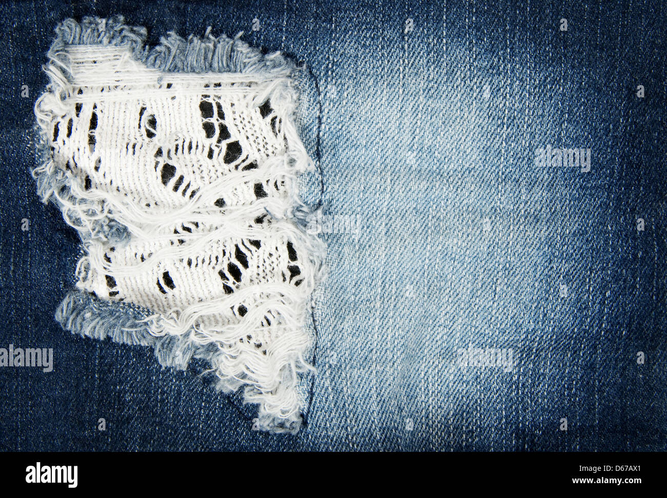 Worn out blue denim fabric. Close-up of old jeans. Stock Photo