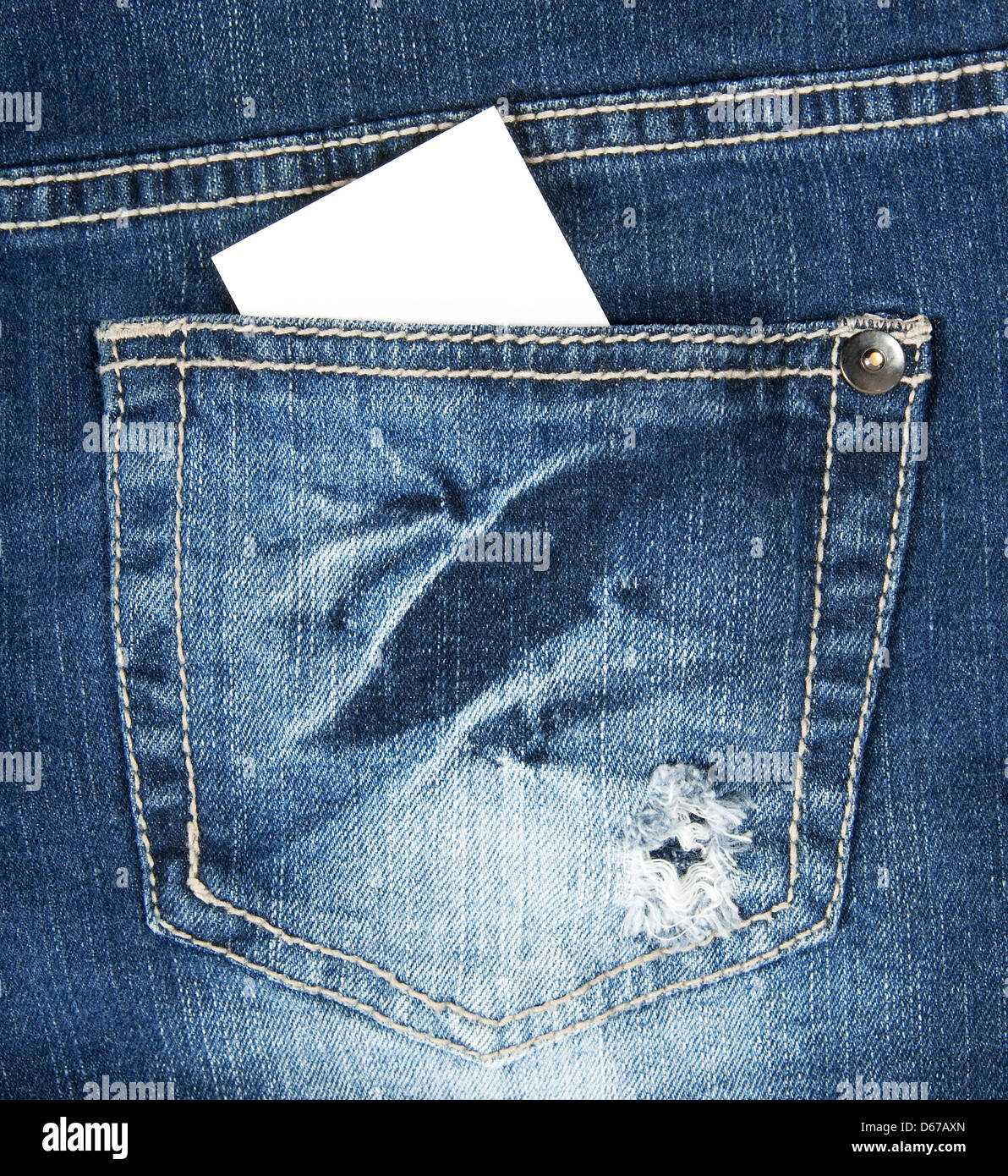 Blank business card with copy space in a pocket of blue worn out jeans. Stock Photo
