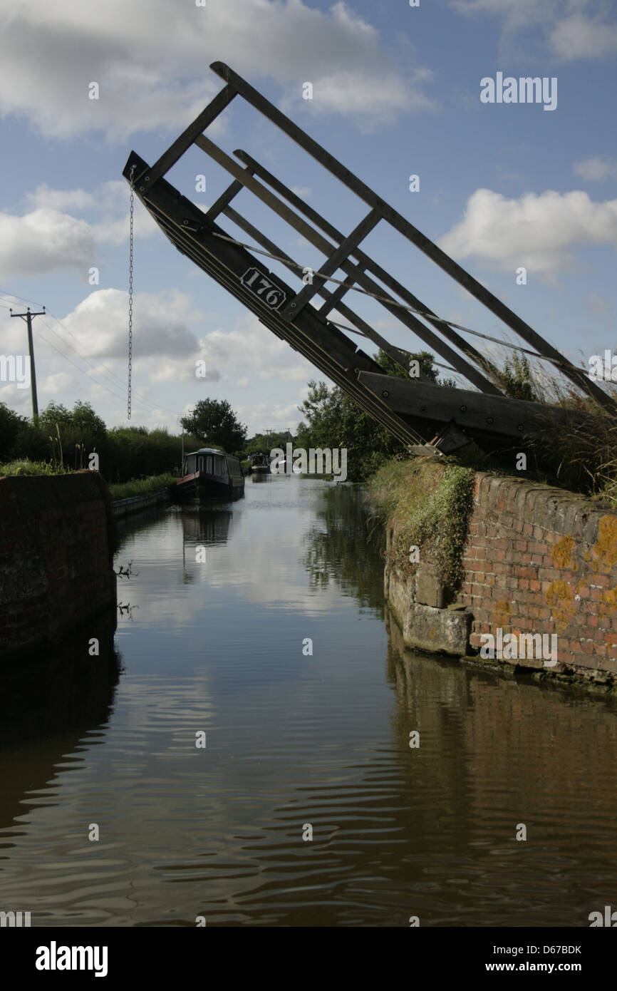 Oxford Canal lifting bridge. Stevens Bridge. Between Banbury and Lower Heyford. Narrow boats moored by the bank. Stock Photo