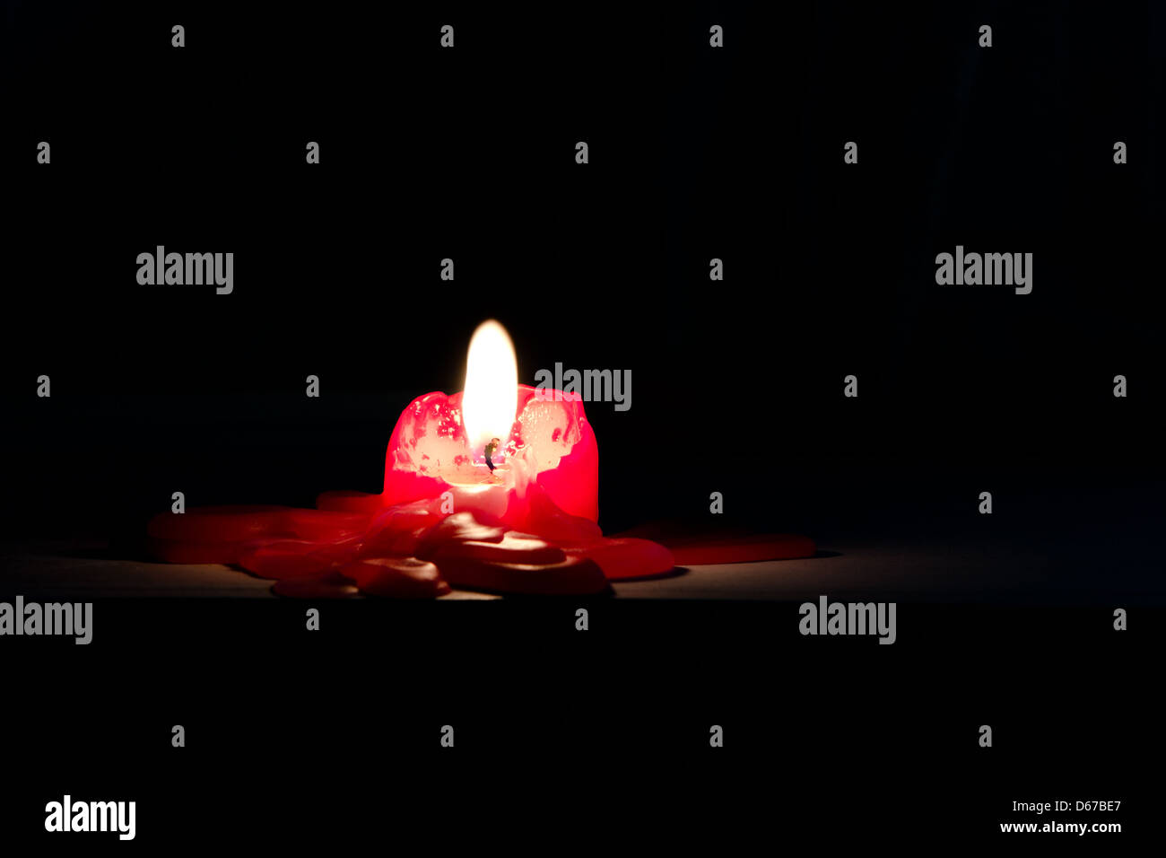 Red candle. Wax melting on the table Stock Photo Alamy