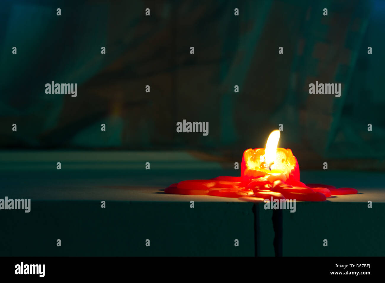 Red candle. Wax melting on the table Stock Photo Alamy