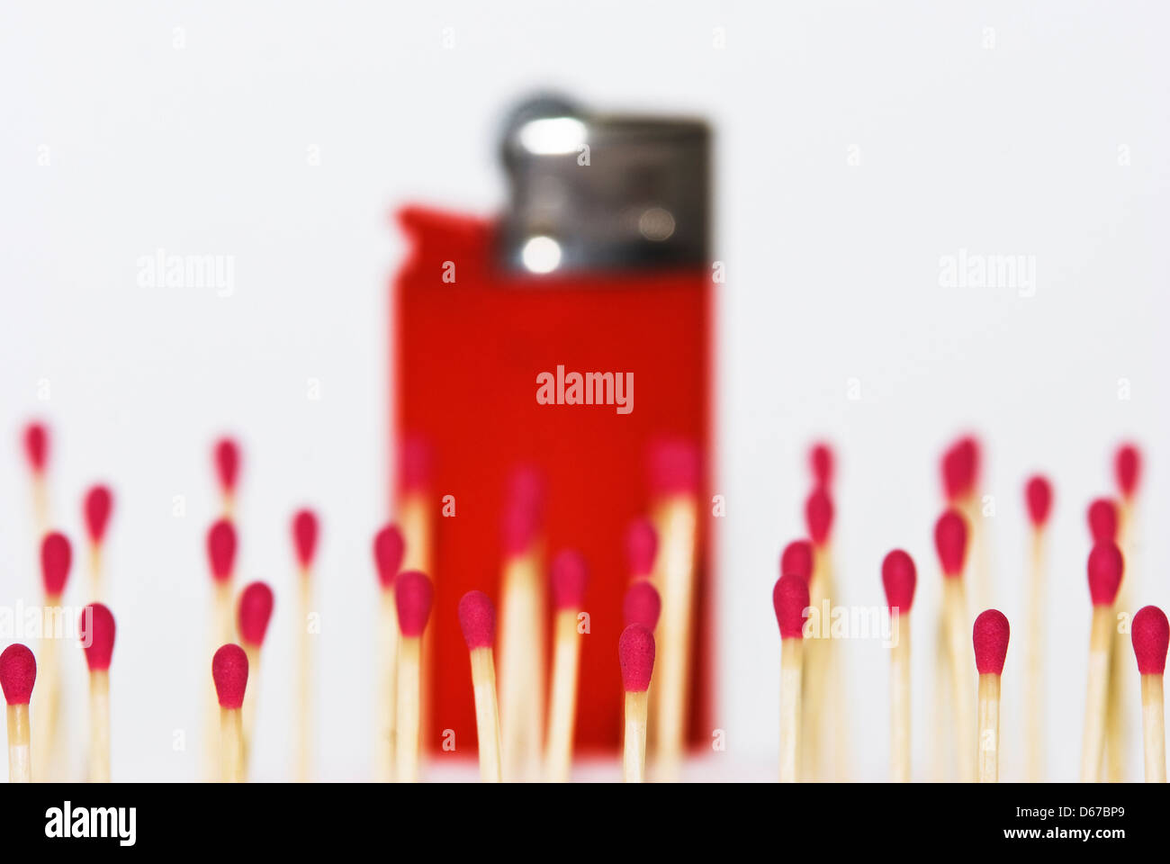 Group of matches versus a lighter red Stock Photo