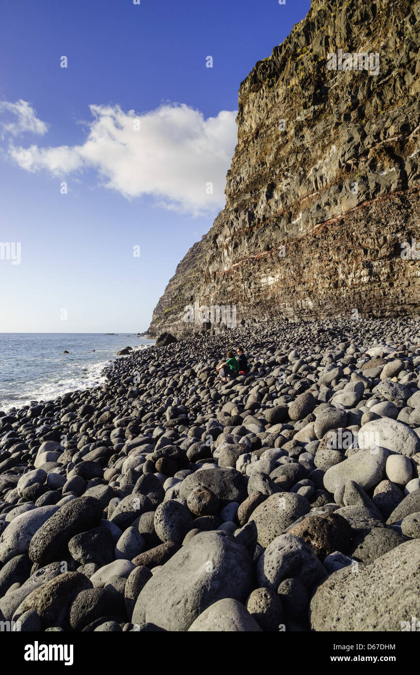 Lava cliff and rounded boulder, Tazacorte beach La Palma Stock Photo
