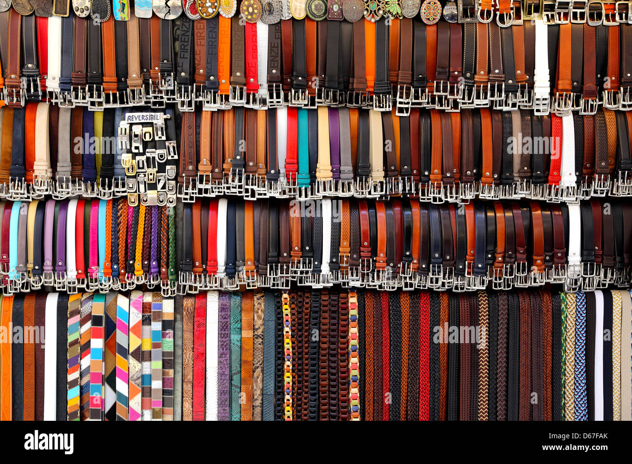 Leather belts on display at a market in Florence Italy Stock Photo