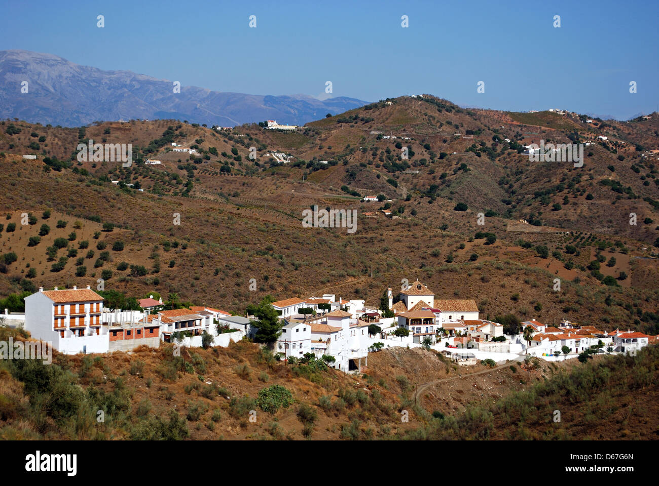 View of white village and surrounding countryside, Macharaviaya, Malaga Province, Andalucia, Spain, Western Europe. Stock Photo