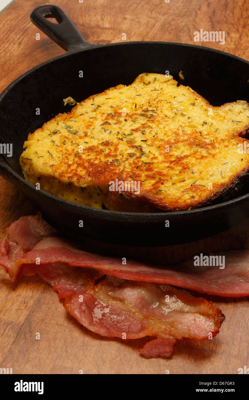 Frying bacon in stainless steel frying pan on stove top Stock Photo - Alamy