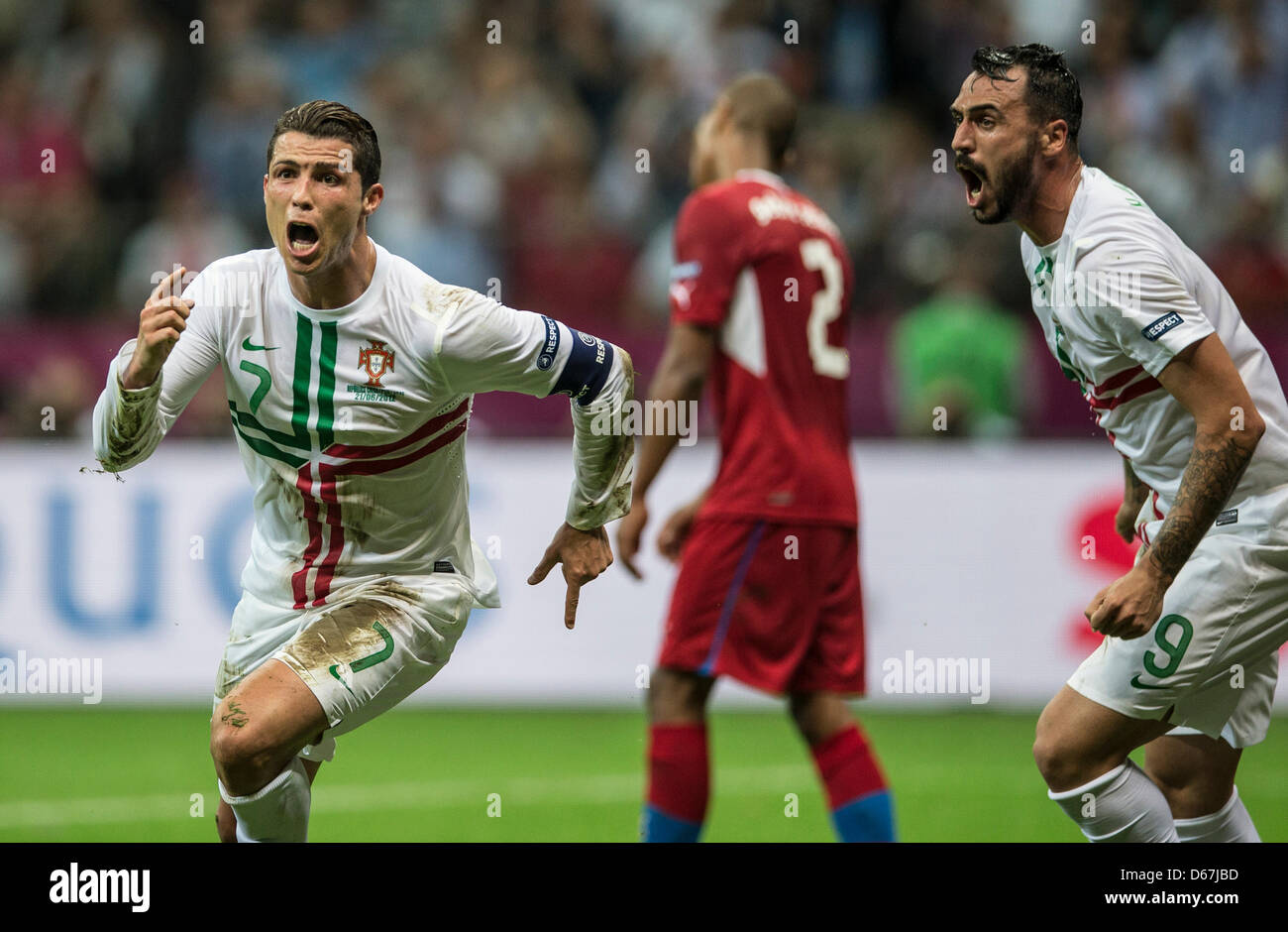 Portugal's Cristiano Ronaldo celebrates scoring the 1-0 with team mate Hugo Almeida during the UEFA EURO 2012 quarter-final soccer match Czech Republic vs Portugal at the National Stadium in Warsaw, Poland, 21 June 2012. Photo: Jens Wolf dpa (Please refer to chapters 7 and 8 of http://dpaq.de/Ziovh for UEFA Euro 2012 Terms & Conditions)  +++(c) dpa - Bildfunk+++ Stock Photo