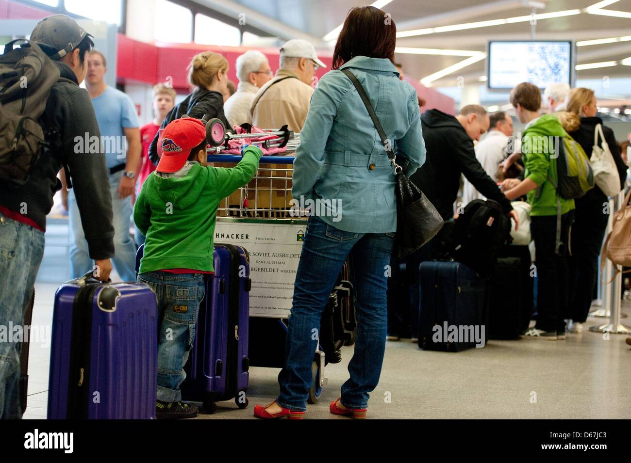 Passengers are pictured at Tegel airport in Berlin, Germany, 22 June 2012. The majority of Germans want to treat themselves to a holiday far away this summer. Photo: SEBASTIAN KAHNERT Stock Photo