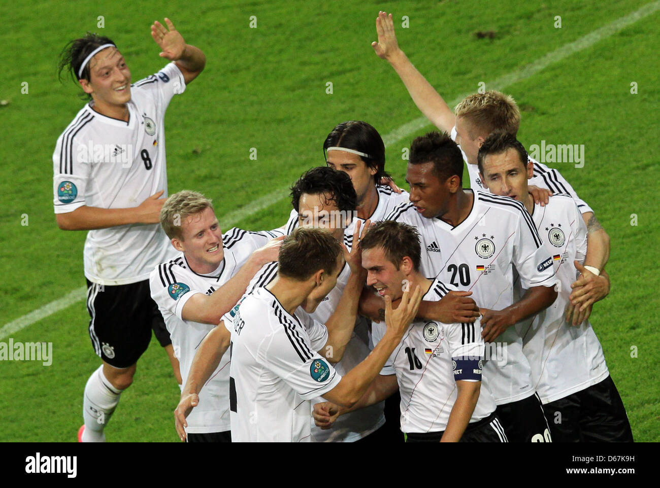 Germany's Philipp Lahm (C) celebrates with team mates after scoring the 1-0 next to Greece's Giorgos Tzavellas during UEFA EURO 2012 quarter- final soccer match Germany vs Greece at Arena Gdansk in Gdansk, Poland, 22 June 2012. Photo: Jens Wolf dpa (Please refer to chapters 7 and 8 of http://dpaq.de/Ziovh for UEFA Euro 2012 Terms & Conditions) Stock Photo
