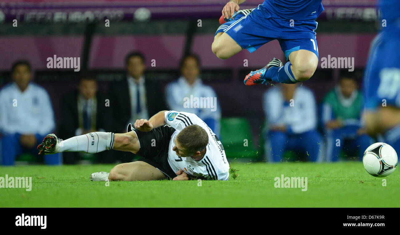 Germany's Bastian Schweinsteiger (L) and Greece's Dimitris Salpingidis vie for the ball during UEFA EURO 2012 quarter-final soccer match Germany vs Greece at Arena Gdansk in Gdansk, Poland, 22 June 2012. Photo: Marcus Brandt dpa (Please refer to chapters 7 and 8 of http://dpaq.de/Ziovh for UEFA Euro 2012 Terms & Conditions)  +++(c) dpa - Bildfunk+++ Stock Photo