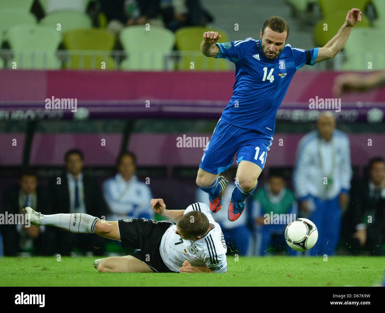 Germany's Bastian Schweinsteiger (L) and Greece's Dimitris Salpingidis vie for the ball during UEFA EURO 2012 quarter-final soccer match Germany vs Greece at Arena Gdansk in Gdansk, Poland, 22 June 2012. Photo: Marcus Brandt dpa (Please refer to chapters 7 and 8 of http://dpaq.de/Ziovh for UEFA Euro 2012 Terms & Conditions)  +++(c) dpa - Bildfunk+++ Stock Photo