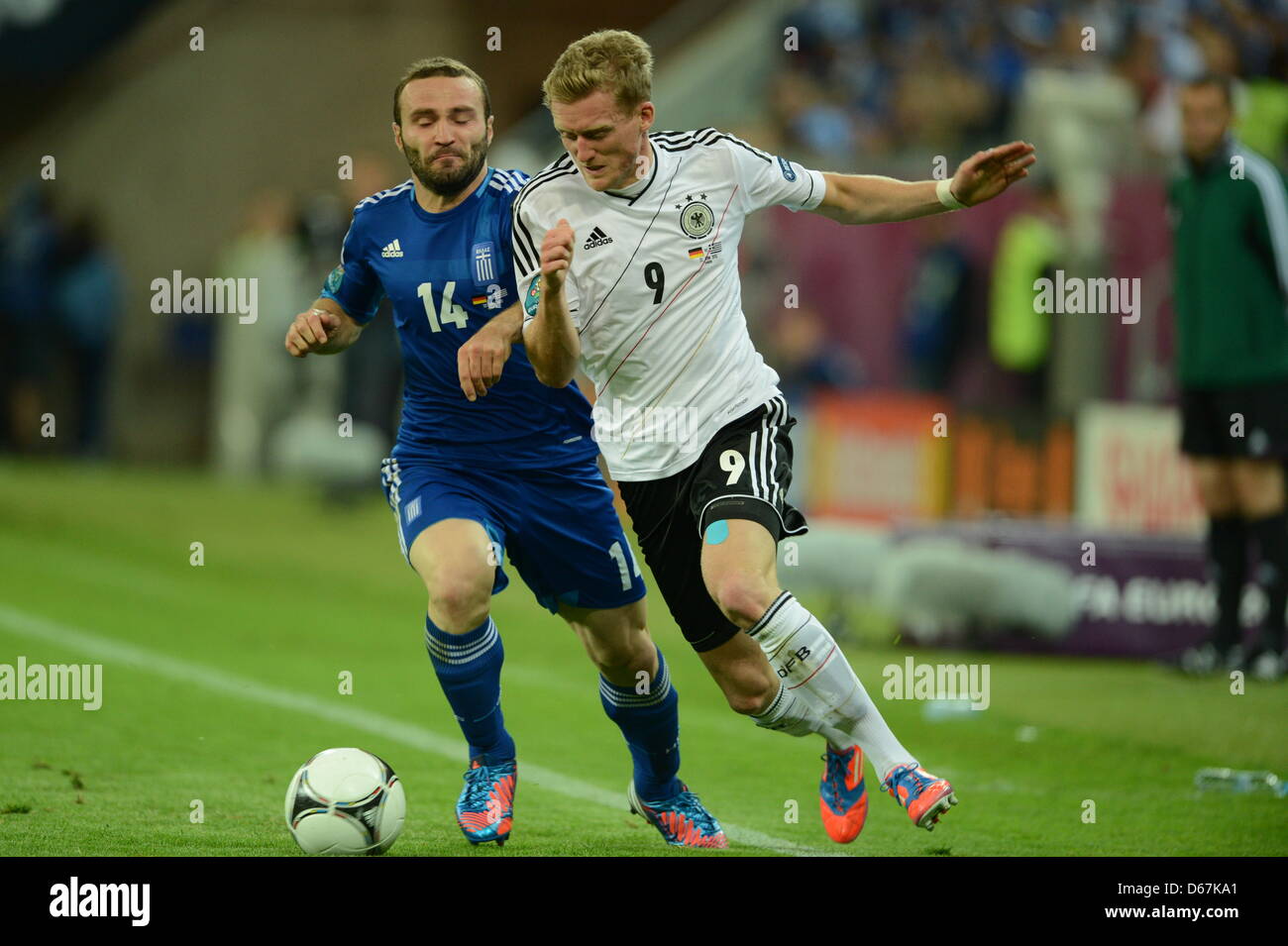 Germany's Andre Schuerrle (R) and Greece's Dimitris Salpingidis vie for the ball during UEFA EURO 2012 quarter-final soccer match Germany vs Greece at Arena Gdansk in Gdansk, Poland, 22 June 2012. Photo: Andreas Gebert dpa (Please refer to chapters 7 and 8 of http://dpaq.de/Ziovh for UEFA Euro 2012 Terms & Conditions)  +++(c) dpa - Bildfunk+++ Stock Photo
