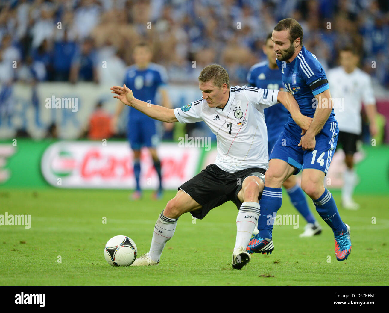 Germany's Bastian Schweinsteiger (L) and Greece's Dimitris Salpingidis vie for the ball during UEFA EURO 2012 quarter-final soccer match Germany vs Greece at Arena Gdansk in Gdansk, Poland, 22 June 2012. Photo: Andreas Gebert dpa (Please refer to chapters 7 and 8 of http://dpaq.de/Ziovh for UEFA Euro 2012 Terms & Conditions)  +++(c) dpa - Bildfunk+++ Stock Photo