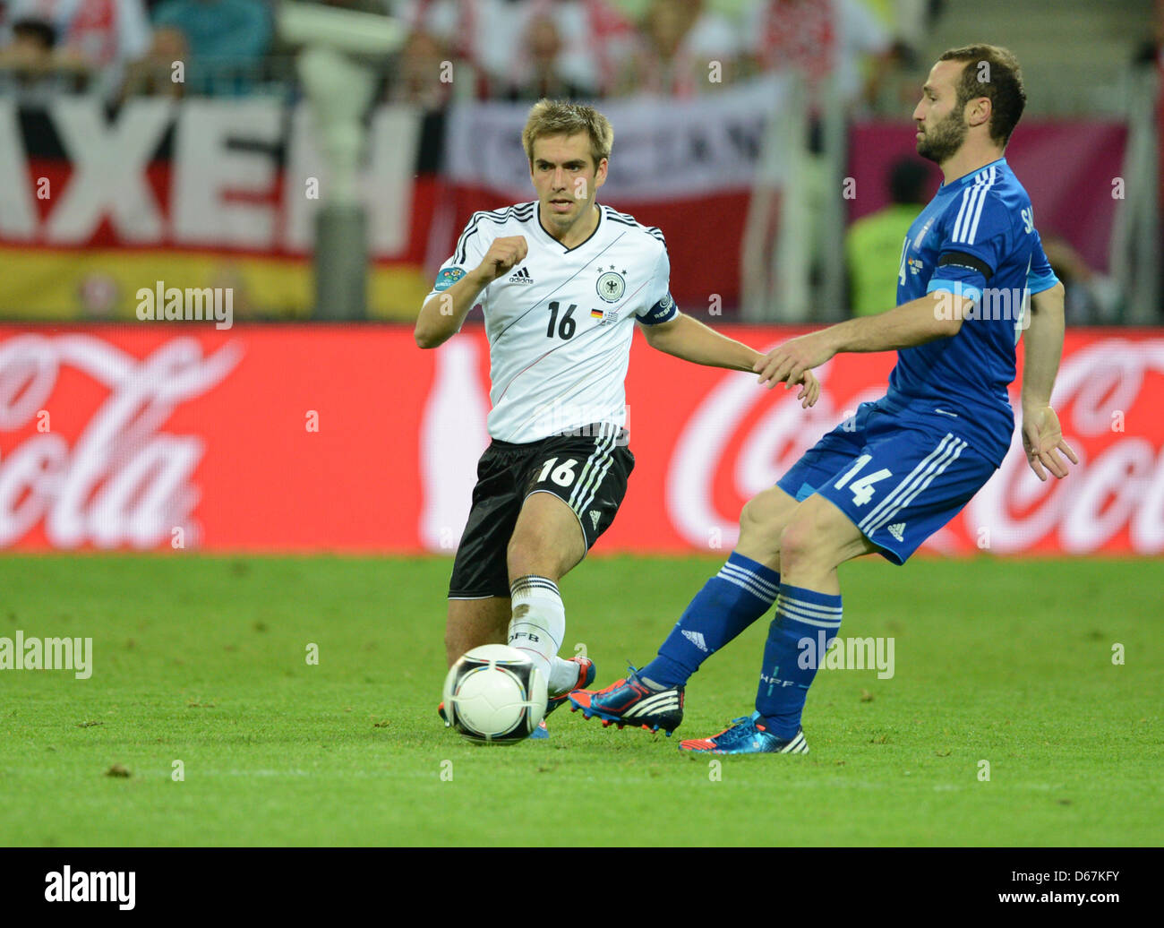 Germany's Philipp Lahm (L) and Greece's Dimitris Salpingidis vie for the ball during the UEFA EURO 2012 quarter-final soccer match Germany vs Greece at Arena Gdansk in Gdansk, Poland, 22 June 2012. Photo: Andreas Gebert dpa (Please refer to chapters 7 and 8 of http://dpaq.de/Ziovh for UEFA Euro 2012 Terms & Conditions) Stock Photo
