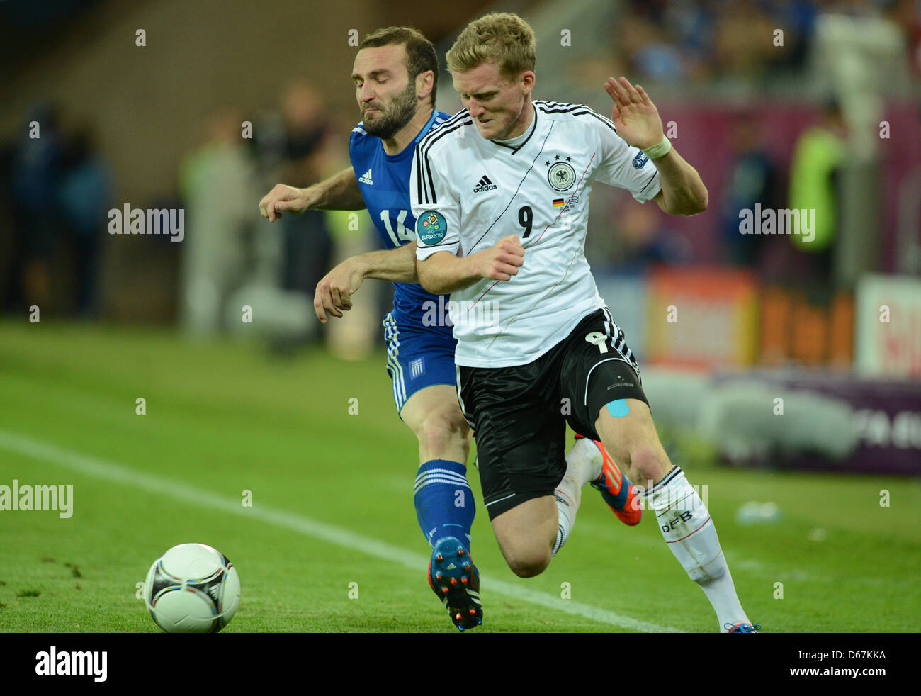 Germany's Andre Schuerrle (R) and Dimitris Salpingidis vie for the ball during the UEFA EURO 2012 quarter-final soccer match Germany vs Greece at Arena Gdansk in Gdansk, Poland, 22 June 2012. Photo: Andreas Gebert dpa (Please refer to chapters 7 and 8 of http://dpaq.de/Ziovh for UEFA Euro 2012 Terms & Conditions) Stock Photo