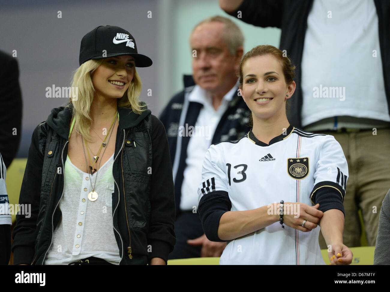 Lena Gercke, the girlfriend of Sami Khedira and Lisa Mueller, the wife of  Thomas Mueller, on the stand prior to the UEFA EURO 2012 quarter-final  soccer match Germany vs Greece at Arena
