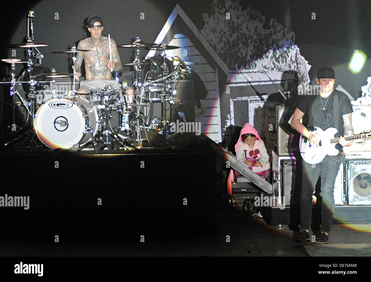 US punk band Blink-182's singer Tom DeLonge (r) and drummer Travis Barker perform on stage, while a child sits with them, during the Hurrican Festival in Scheessel, Germany, 23 June 2012. The sold-out festival takes place until 24 June and is attended by 73 000 visitors. Photo: Daniel Reinhardt Stock Photo