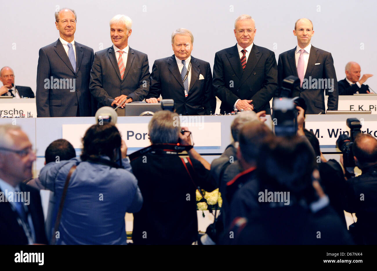 CFO of Porsche SE, Hans Dieter Poetsch (L-R), CEO of Porsche AG, Matthias Mueller, chairman of the supervisory board, Wolfgang Porsche, and CEO of Volkswagen AG, Martin Winterkorn and board member of Porsche SE, Philipp von Hagen, stand on a stage at the general meeting of Porsche SE in Stuttgart, Germany, 25 June 2012. Porsche SE owns most of Volkswagen's common shares, as well as Stock Photo