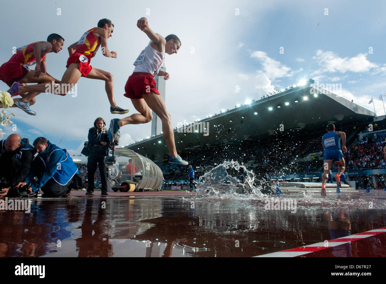 Runners jump in the mens 3000 Meter Steeplechase Semifinal at the ...