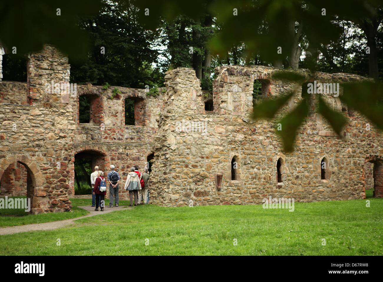 Tourists are pictured at the ruins of the Klosterkirche Nimbschen (Monastery Church Nimbschen) close to Grimma, Germany, 27 June 2012. In the course of two-month-long excavations on the site of the ruins of the monastery, its foundations as well as a stoup made from Rochlitz Porphyr were discovered. The Cistercian monastery Nimbschen once was the residence of Katharina von Bora, th Stock Photo