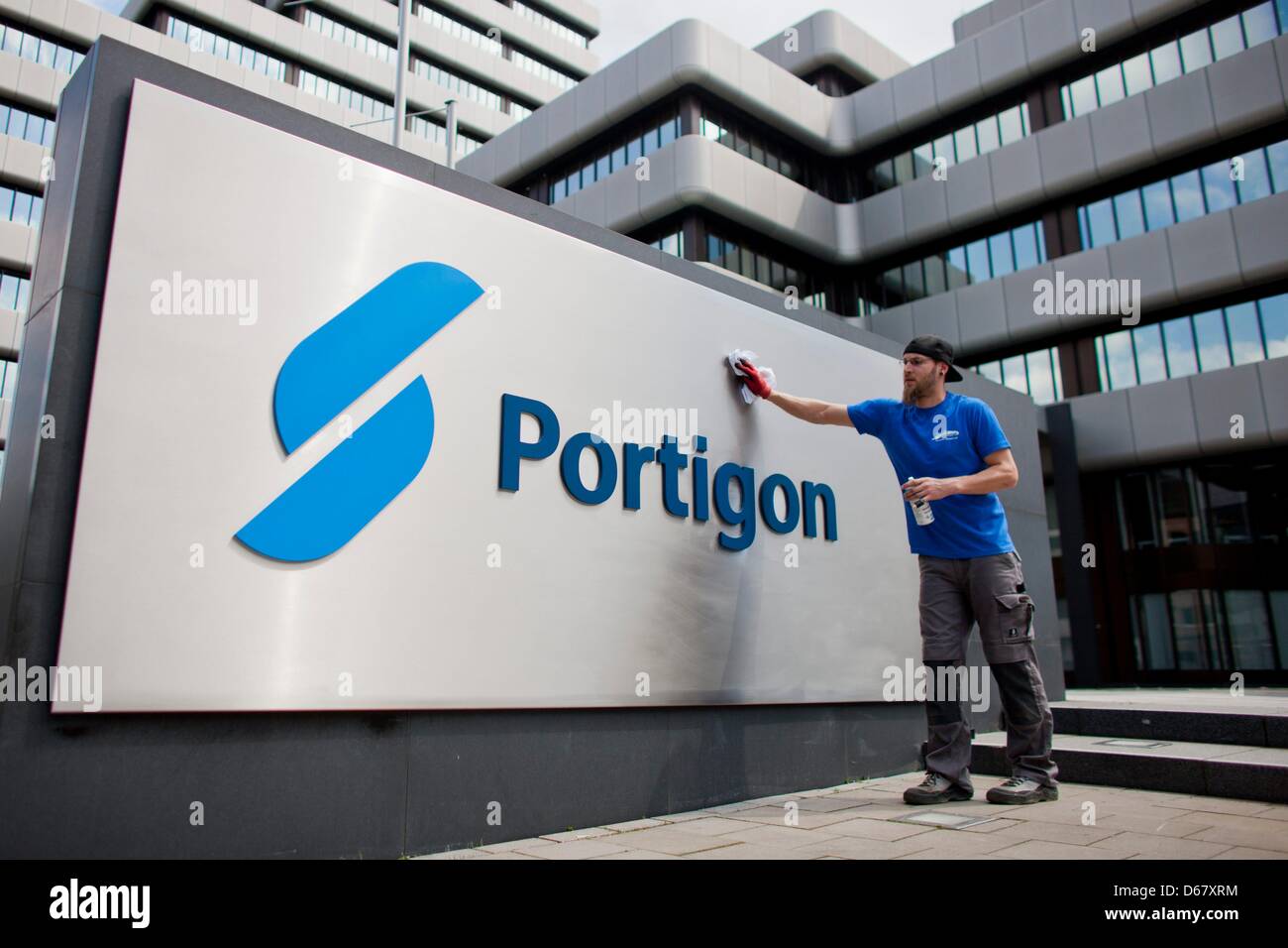 A Staff Member Cleans The New Company S Sign At The Headquarters