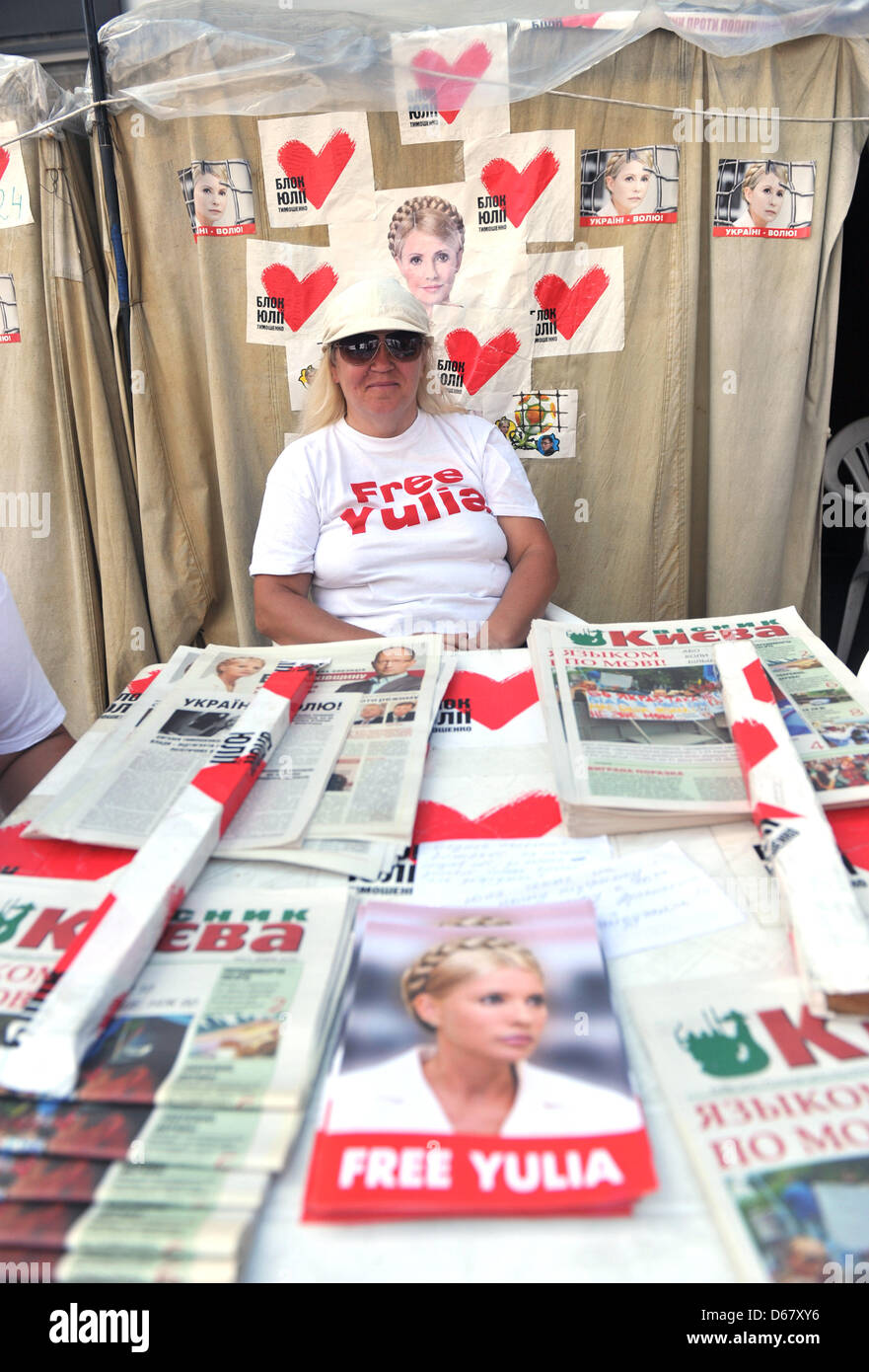 An activist sits in front of photos of the Ukranian politician Yulia Tymoshenko in a protest camp in downtown Kiev, Ukraine, 30 June 2012. The Euro 2012 championships were discussed controversially over the case of Ukraine's jailed former Prime Minister Yulia Tymoshenko. Photo: ANDREAS GEBERT Stock Photo