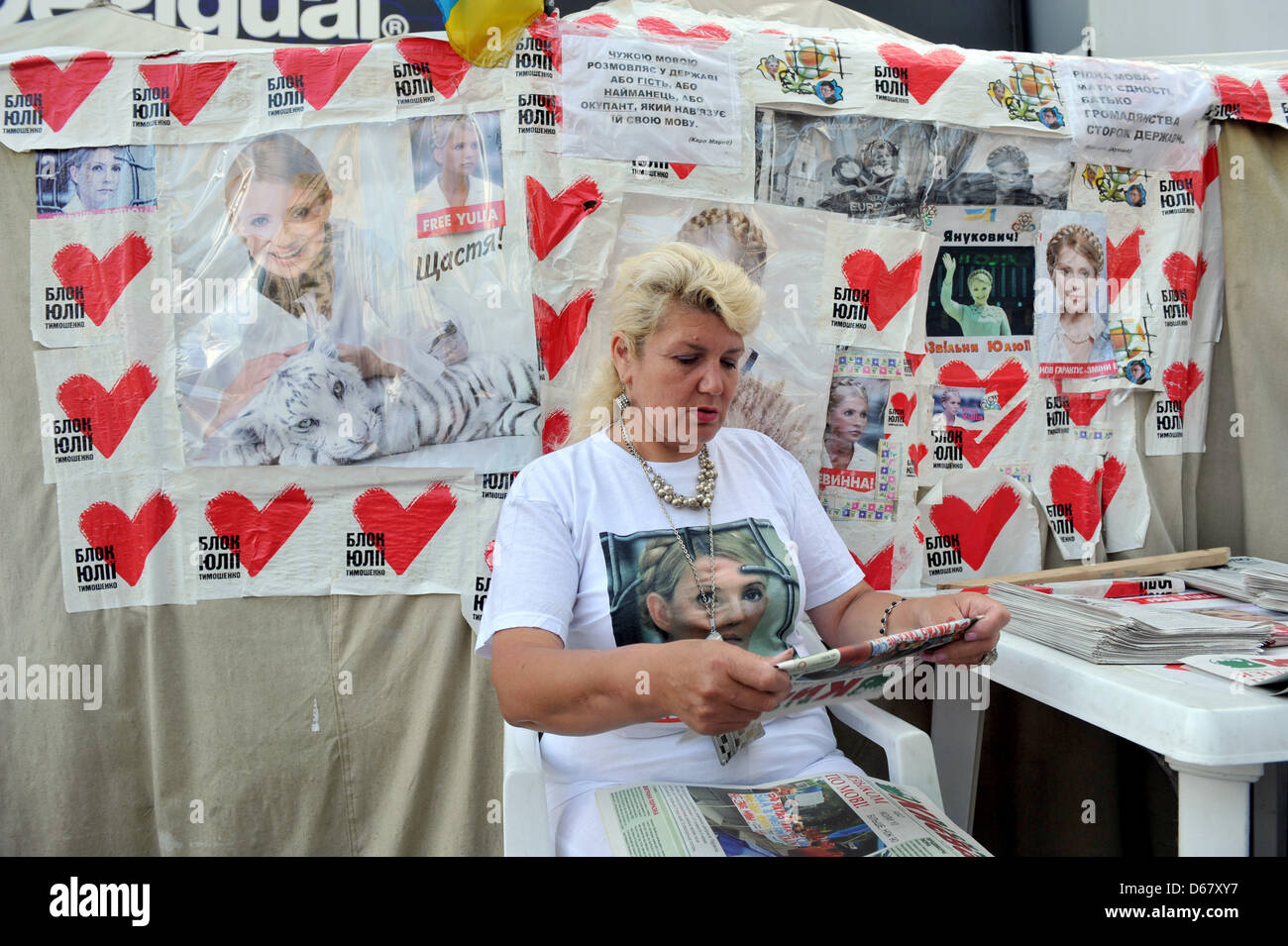 An activist sits in front of photos of the Ukranian politician Yulia Tymoshenko in a protest camp in downtown Kiev, Ukraine, 30 June 2012. The Euro 2012 championships were discussed controversially over the case of Ukraine's jailed former Prime Minister Yulia Tymoshenko. Photo: ANDREAS GEBERT Stock Photo