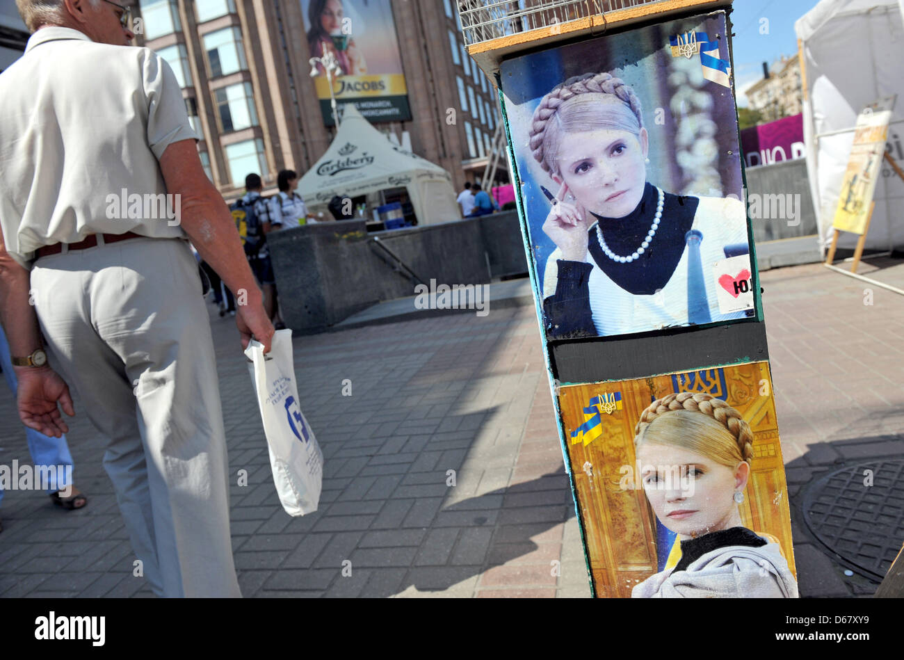 A man walks past photos of the Ukranian politician Yulia Tymoshenko in a protest camp in downtown Kiev, Ukraine, 30 June 2012. The Euro 2012 championships were discussed controversially over the case of Ukraine's jailed former Prime Minister Yulia Tymoshenko. Photo: ANDREAS GEBERT Stock Photo
